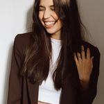 Portrait of a smiling woman with a calm and confident expression.