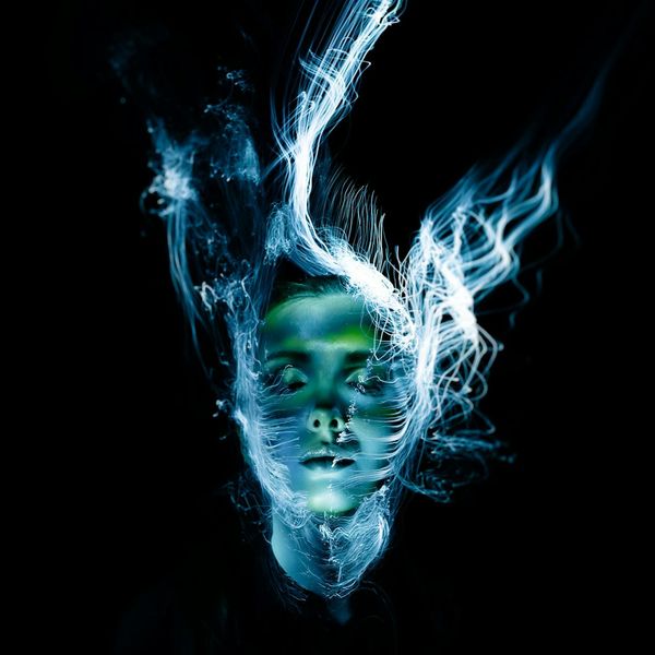 Silhouette of a person in a dynamic, flowing pose against a dark background.